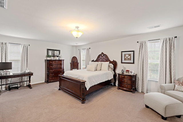 bedroom featuring visible vents, baseboards, and light colored carpet