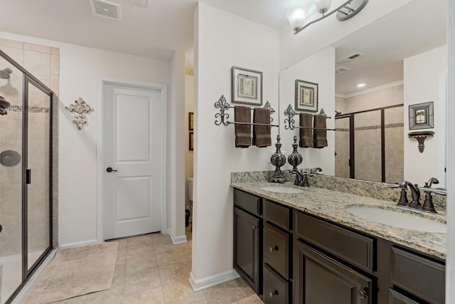 bathroom with double vanity, visible vents, a sink, and a stall shower