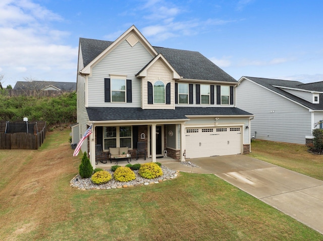 view of front of house with a front yard, a porch, an attached garage, fence, and driveway