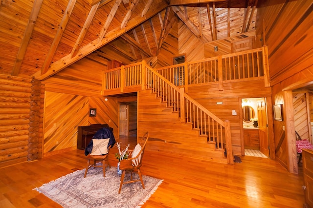 144 Lakeshore, Chesnee, SC 29323 - staircase featuring wooden walls, beam ceiling, high vaulted ceiling, and wood finished floors