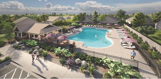 community pool with a patio and fence