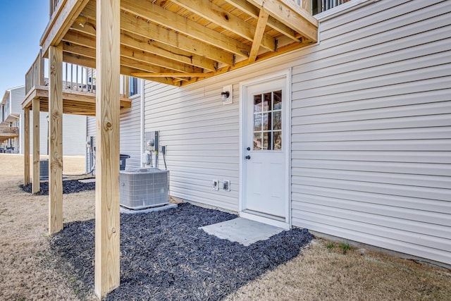 view of exterior entry featuring central AC unit