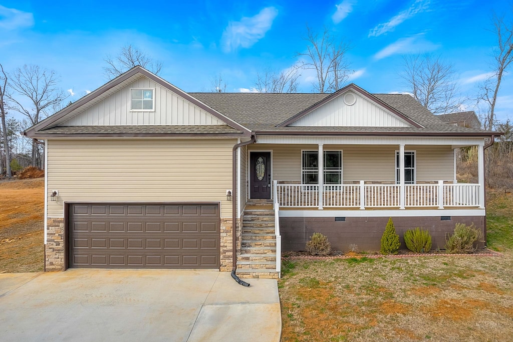 11 Arlington Rd, Greer, SC 29651 - view of front of house featuring a porch, board and batten siding, concrete driveway, and roof with shingles