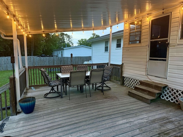 deck featuring outdoor dining area, a fenced backyard, and entry steps