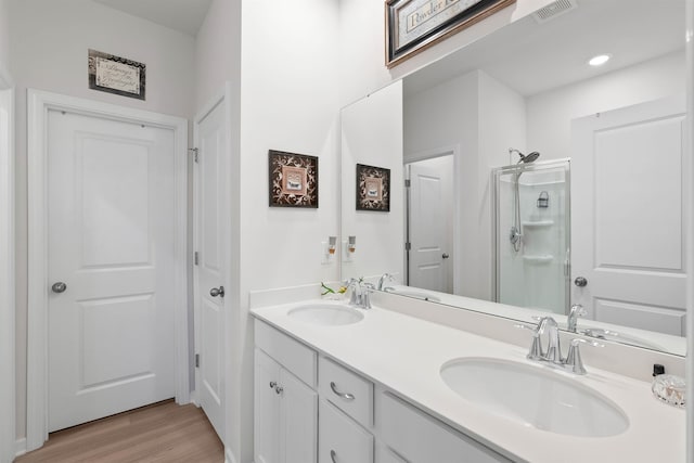 122 Aleppo, Greer, SC 29651 - bathroom with visible vents, a sink, a stall shower, and wood finished floors