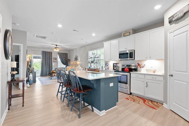 122 Aleppo, Greer, SC 29651 - kitchen featuring a sink, appliances with stainless steel finishes, a kitchen bar, light wood finished floors, and a center island with sink