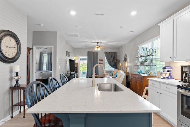 122 Aleppo, Greer, SC 29651 - kitchen with a sink, visible vents, light wood finished floors, and a kitchen island with sink