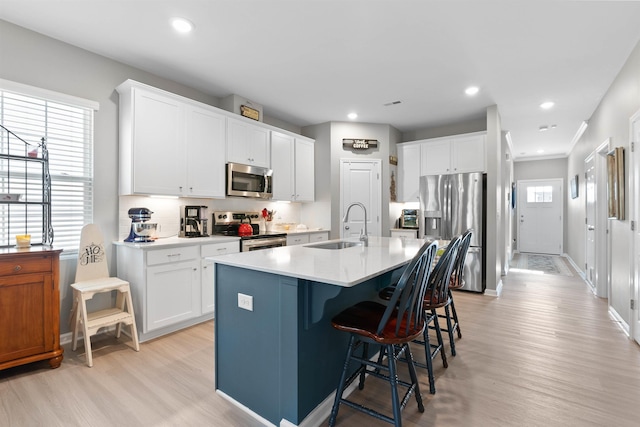 122 Aleppo, Greer, SC 29651 - kitchen with a breakfast bar, appliances with stainless steel finishes, a sink, light wood finished floors, and backsplash