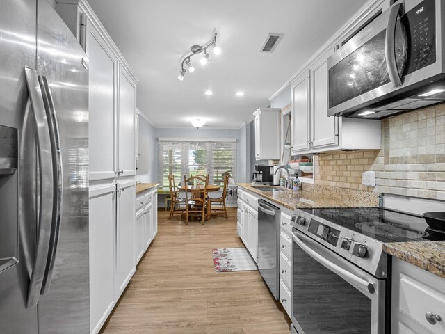 110 Miller Spgs, Moore, SC 29369 - kitchen featuring visible vents, white cabinets, a sink, appliances with stainless steel finishes, and crown molding