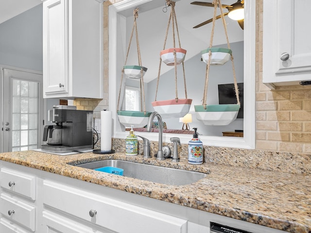 110 Miller Spgs, Moore, SC 29369 - kitchen featuring ceiling fan, white cabinetry, a sink, lofted ceiling, and backsplash