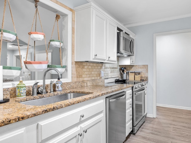 110 Miller Spgs, Moore, SC 29369 - kitchen with white cabinets, appliances with stainless steel finishes, light stone counters, a sink, and decorative backsplash