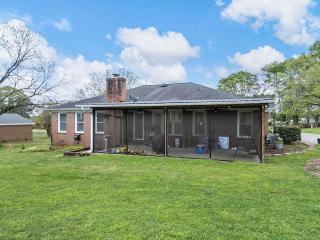 110 Miller Spgs, Moore, SC 29369 - rear view of property with a sunroom, brick siding, a chimney, and a lawn