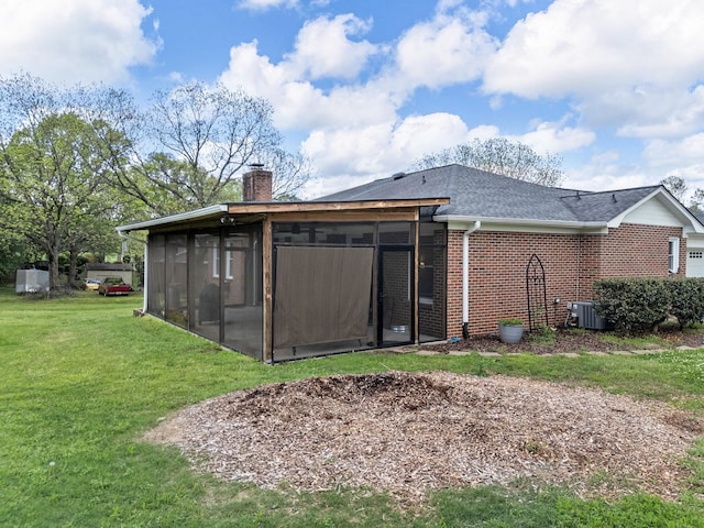 110 Miller Spgs, Moore, SC 29369 - back of house featuring a sunroom, central air condition unit, a yard, brick siding, and a chimney