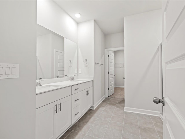 217 Merriweather, Spartanburg, SC 29301 - bathroom featuring double vanity, tile patterned flooring, a spacious closet, and baseboards