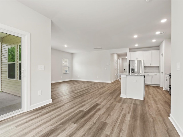 217 Merriweather, Spartanburg, SC 29301 - unfurnished living room featuring light wood finished floors, recessed lighting, and baseboards
