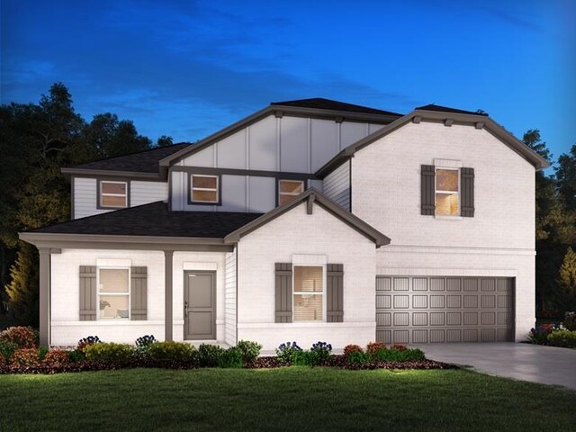 843 Burghley, Greer, SC 29651 - view of front facade with board and batten siding, a garage, concrete driveway, and a front yard