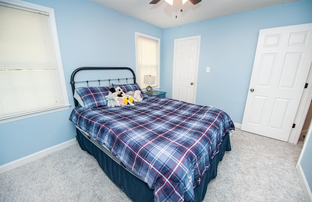 bedroom with carpet flooring, baseboards, and a ceiling fan