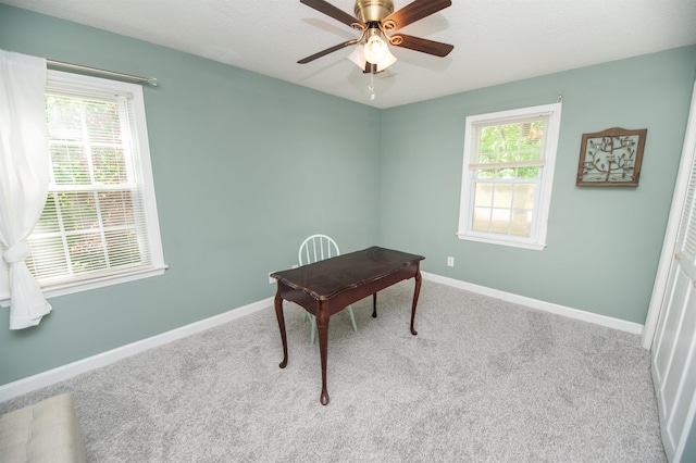 office area featuring carpet flooring, ceiling fan, and baseboards