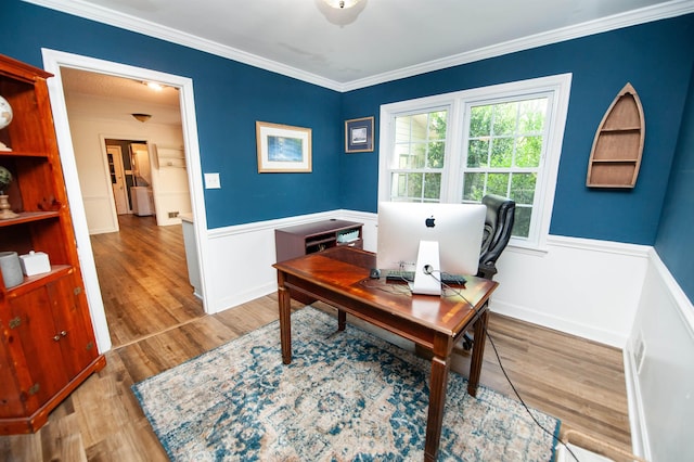 office space featuring wainscoting, baseboards, crown molding, and wood finished floors