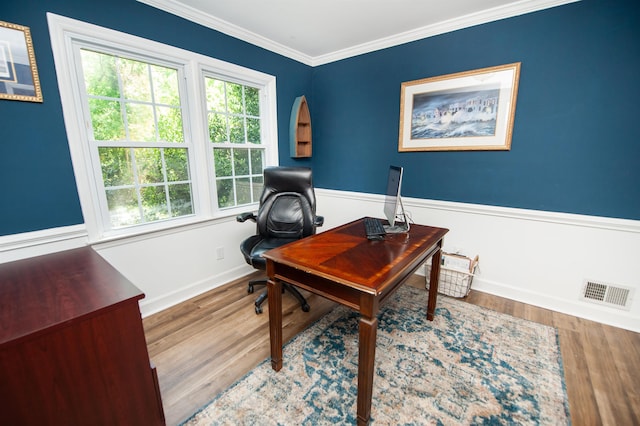 office area with visible vents, baseboards, ornamental molding, and wood finished floors