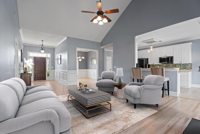 208 W Coosaw, Roebuck, SC 29376 - living room with light wood-style flooring, crown molding, a wainscoted wall, high vaulted ceiling, and ceiling fan with notable chandelier