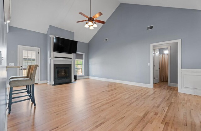208 W Coosaw, Roebuck, SC 29376 - unfurnished living room with high vaulted ceiling, plenty of natural light, a fireplace with flush hearth, ceiling fan, and visible vents