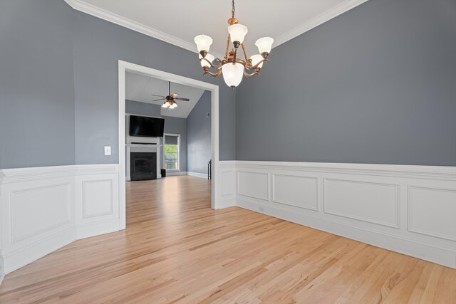 208 W Coosaw, Roebuck, SC 29376 - unfurnished dining area featuring ornamental molding, light wood-style floors, a fireplace, and ceiling fan with notable chandelier