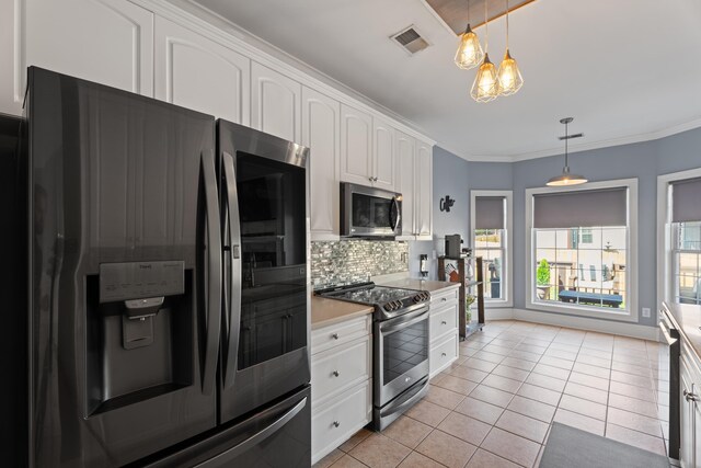 208 W Coosaw, Roebuck, SC 29376 - kitchen featuring visible vents, light tile patterned floors, light countertops, appliances with stainless steel finishes, and white cabinetry