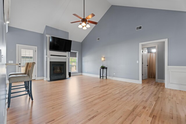 208 W Coosaw, Roebuck, SC 29376 - unfurnished living room with light wood-type flooring, a fireplace with flush hearth, visible vents, ceiling fan, and high vaulted ceiling