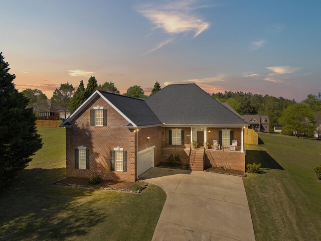 208 W Coosaw, Roebuck, SC 29376 - traditional-style house with a shingled roof, a yard, a porch, brick siding, and driveway