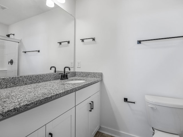 full bathroom with vanity, toilet, a shower, and visible vents