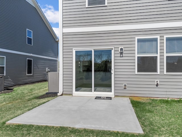rear view of property with a lawn and a patio