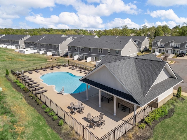pool featuring a residential view, a patio, and fence