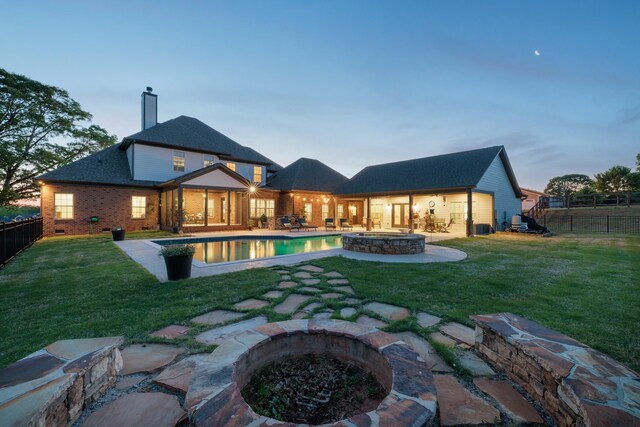 865 Westmoreland, Greer, SC 29651 - back of house at dusk featuring a chimney, a fenced backyard, a yard, a patio area, and an outdoor fire pit