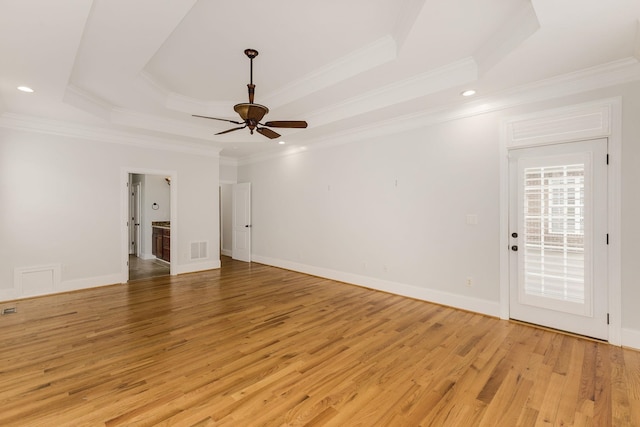 6 Pepper Bush, Greer, SC 29651 - spare room with visible vents, light wood-style floors, a raised ceiling, and crown molding