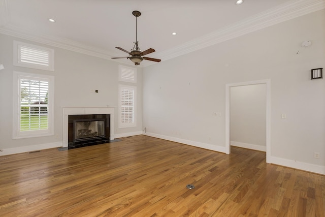 6 Pepper Bush, Greer, SC 29651 - unfurnished living room with light wood finished floors, a fireplace with flush hearth, baseboards, a ceiling fan, and ornamental molding