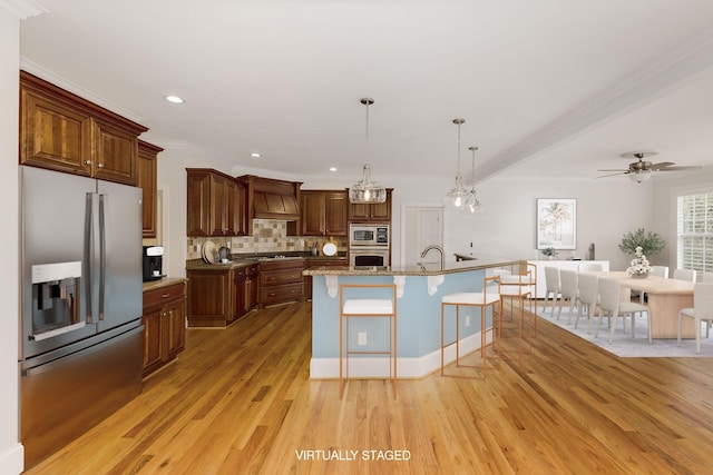 6 Pepper Bush, Greer, SC 29651 - kitchen featuring light wood finished floors, crown molding, decorative backsplash, a kitchen bar, and appliances with stainless steel finishes