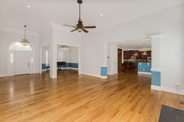6 Pepper Bush, Greer, SC 29651 - unfurnished living room with light wood-type flooring, crown molding, baseboards, and ceiling fan