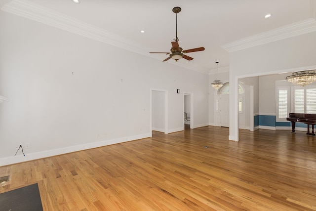 6 Pepper Bush, Greer, SC 29651 - unfurnished living room with ceiling fan with notable chandelier, light wood-style flooring, baseboards, ornamental molding, and recessed lighting