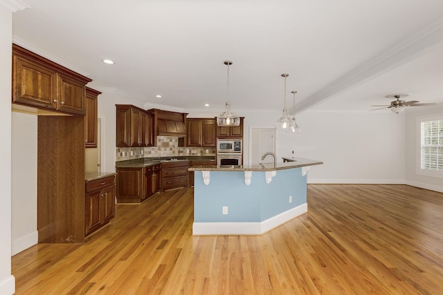 6 Pepper Bush, Greer, SC 29651 - kitchen with backsplash, gas cooktop, stainless steel microwave, light wood-style floors, and a kitchen bar