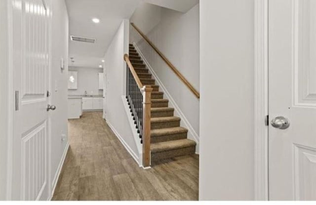 1036 Cargo, Spartanburg, SC 29306 - staircase featuring baseboards, wood finished floors, visible vents, and recessed lighting