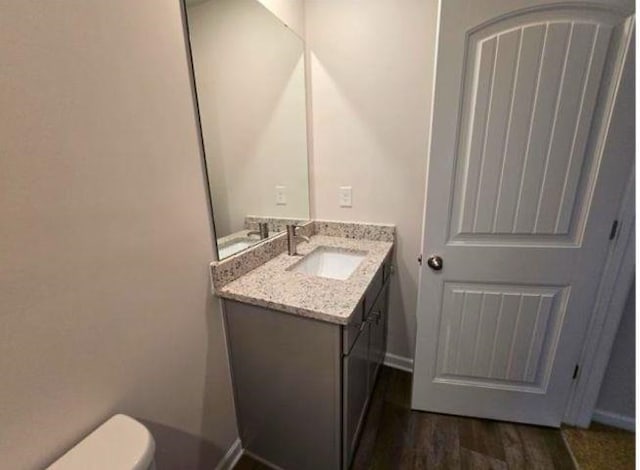1036 Cargo, Spartanburg, SC 29306 - bathroom featuring baseboards, wood finished floors, toilet, and vanity