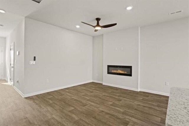 1036 Cargo, Spartanburg, SC 29306 - unfurnished living room with visible vents, a ceiling fan, a glass covered fireplace, and dark wood finished floors
