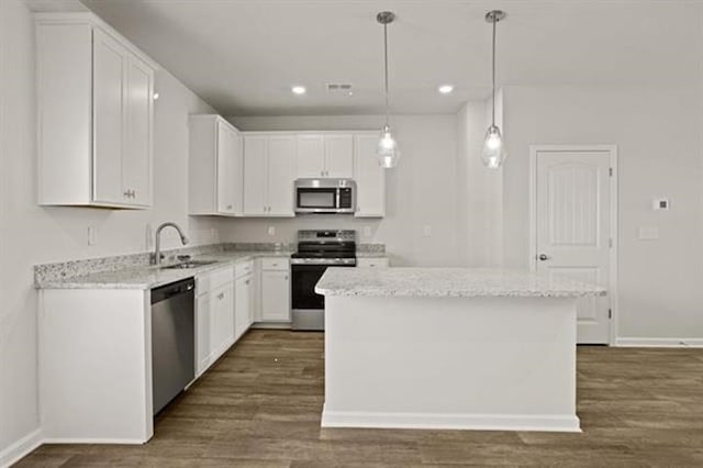 1036 Cargo, Spartanburg, SC 29306 - kitchen featuring white cabinets, baseboards, recessed lighting, dark wood-type flooring, and appliances with stainless steel finishes