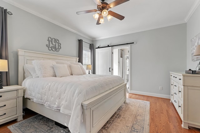 bedroom featuring baseboards, ornamental molding, and light wood-style floors