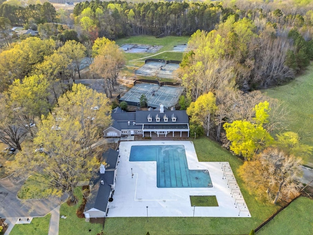birds eye view of property with a wooded view