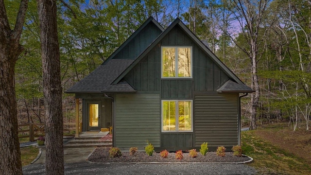 view of home's exterior with board and batten siding and a shingled roof