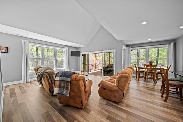 living area featuring baseboards, wood finished floors, recessed lighting, and high vaulted ceiling
