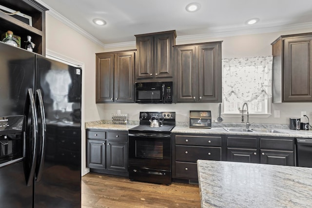 kitchen featuring crown molding, dark brown cabinets, wood finished floors, a sink, and black appliances