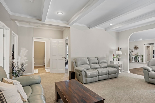 living room with arched walkways, ornamental molding, beam ceiling, and recessed lighting